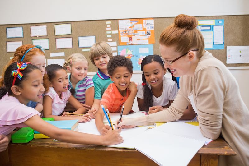 Children communicating with each other and their teacher