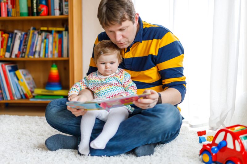 Baby reading with dad