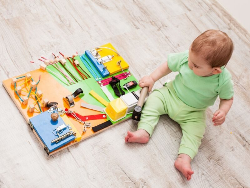 Learning to get dressed with a busy board